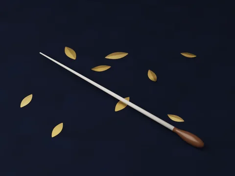 A conductor’s baton on navy leather among gold leaves